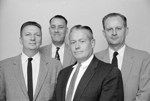 Madison's police chief and his reorganized top echelon. Left to right are: Inspector John H. Harrington, Inspector Richard F. Gruber, Chief Bruce Weatherly, and Inspector Herman J. Thomas.