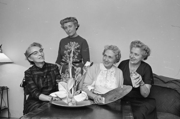 Members of the West Side Garden club admire an arrangement of dried material for their upcoming sale. Members, left to right, are: Ethel Falk, Geneva Lail, Helen Thomsen, and Sarah Longenecker.