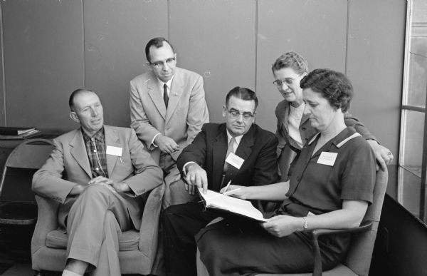 Discussing conference matters at the annual conference of 4-H club leaders are, left to right: Roy Meier, Ogema; Frank Campbell, Madison; Alfred Schmidt, Salem; Agnes Hansen, Madison; and Mrs. Lloyd Drake, Viola.