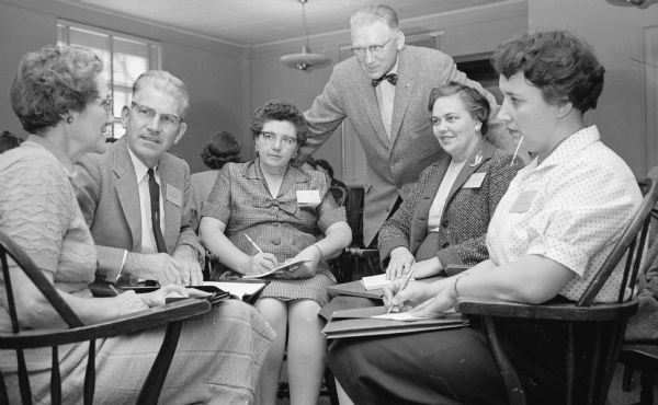 Taking part in a discussion at the annual conference of 4-H club leaders are, left to right: Mrs. Sheldon Russell, Augusta; T.M. Nielsen, Racine; Mrs. Elmer Kern, Menomonie; V.V. Varney, Madison; Mrs. Vernon Horne, Salem; and Mrs. Howard Forman, Boyd.
