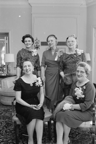 Officers of the State and Dane County Lawyers' Wives Association at a tea at the governor's mansion for members from area counties. In front are Helen Thomson, wife of Govenor Vernon Thomson, left, and Mrs. John Kluwin, Milwaukee. Back row, left to right: Eleanor Bjork, Madison; Inez Toebaas, Madison and Mrs. Harold Hallows, Milwaukee, wife of a Supreme Court Justice and a guest of honor at the tea. 