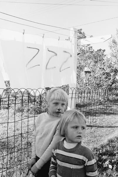 Halloween vandals use black spray paint on east side homes. Paint was sprayed on at least 13 cars and 15 homes on Coolidge, Dahle and Moland Streets. Four boys, 12-16 years old, admitted the spraying and are sent to juvenile authorities. Shown inspecting the damage at 2623 Coolidge Street are, (L-R): Rosemarie Millard (5) and Lois Ann McDonald (4).
