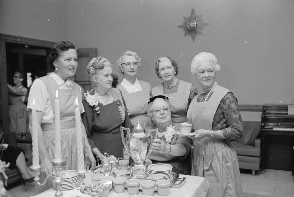 Standing around the tea table at the annual tea at St. Mary's Hospital are, left to right: Helen Grant, Helen Dean, Helen Weber, Patricia Kessenich and Adelaide Yost. Pouring tea is Catherine Crowley.     