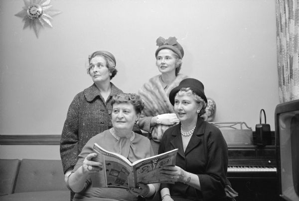 Guests of the annual tea included, left to right, seated: Kathleen Ross, and Gladys Dean. Standing: Margaret Schmitz and Mary Lyons. 