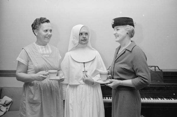 Sister Mary Susanne, director of the School of Nursing at St. Mary's Hospital, chatting with Anne Hibbard, left, and Lenora Buenzli at the annual tea of the St. Mary's Hospital Auxiliary.   