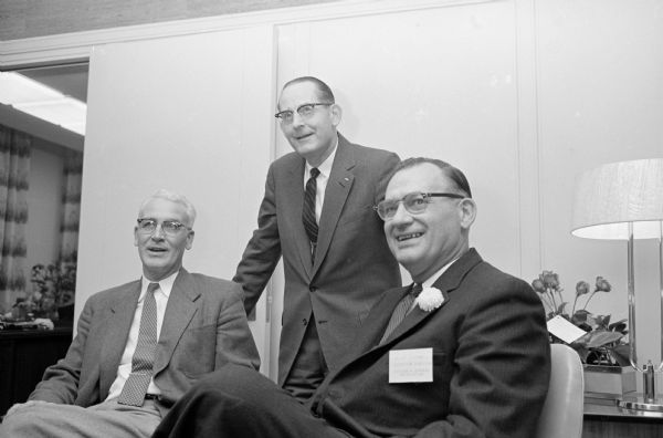 The Wisconsin Bankers Association holds an open house at their new offices in the Wisconsin Power and Light Company building, 122 W. Washington Avenue. Shown at the open house (L-R), are: W. T. Hammill, 4113 Paunack Avenue; G. M. Matthews, 726 Western Avenue; and George Forster, association executive secretary.