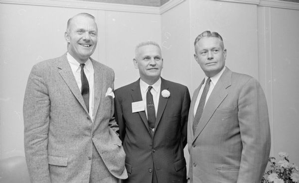 The Wisconsin Bankers Association holds an open house at their new offices in the Wisconsin Power and Light Company building, 122 W. Washington Avenue. Shown at the open house (L-R), are: Robert W. Zimmerman, Wisconsin Secretary of State; Roland W. Blaha, Association President; and Bruce Weatherly, Madison Police Chief.
