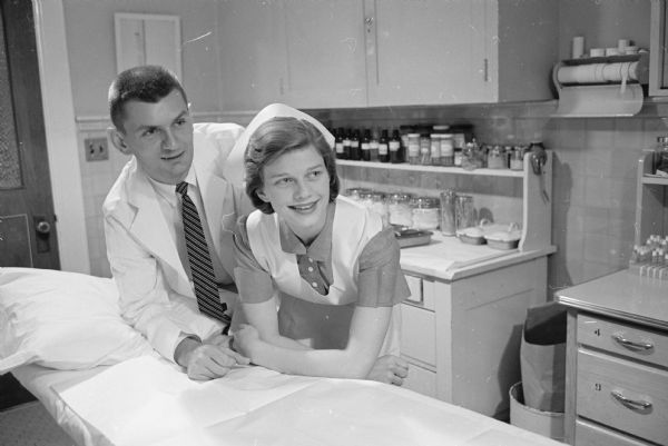 Young couple looks forward to marriage in 1959. Shown are Miss Mary Ragnhild Fenske and Dr. James Russell Hanson. Miss Fenske is a student in the U.W. School of Nursing and will receive her B.S. degree in February of 1961. Her parents are Mr. and Mrs. Miles F. Fenske, 707 S. Orchard Street. Dr. Hanson, son of Circuit Judge and Mrs. Russell E. Hanson, Fond du Lac, is a resident in orthopedic surgery at University Hospital. He will complete his surgical residency in July of 1961.     