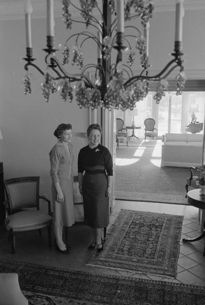 Current First Lady of Wisconsin and wife of Governor Vernon W. Thomson, (right). gives a tour of the Governor's Mansion, 101 Cambridge Road, Maple Bluff, to the future First Lady and wife of the Governor-Elect Gaylord Nelson prior to the Nelson family moving into the mansion in 1959.   