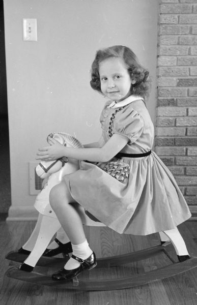 Laurie Stein (age 5) on a rocking horse.