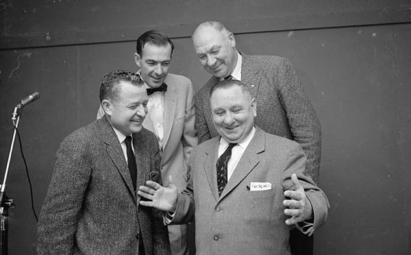 L.T. (Dutch) Midland appears to be telling a fish story at the annual Rounder's Club Christmas party. Looking on are, left to right: Henry Soldwedel, William (Bill) Minnick, and Arthur (Dynie) Mansfield.