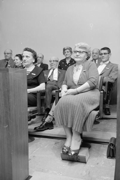 A juror uses a book to rest her feet on during a trial of tavern owner Ray W. Karasek.