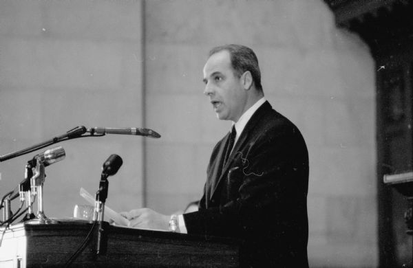 Photograph of Gov. Gaylord Nelson delivering a speech at a podium asking the state's lawmakers to help create a Wisconsin Economic Resources Commission to spur economic expansion and thereby increase tax revenue without raising tax rates.