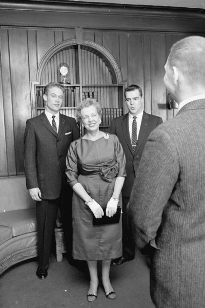 Three Sigma Alpha Epsilon fraternity members admire their housemother's new dress. Margaret Lewis is admired by students Harry Snyder, Robert Devlin, and Richard Leifer.