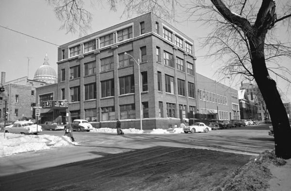 View across W. Doty Street towards the Madison Newspaper, Inc. building at 115 S. Carroll Street. Home of the Wisconsin State Journal and The Capital Times newspapers. The Wisconsin State Capitol is in the background. Snow is on the ground.