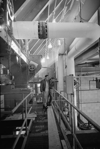Frank Kasiniski of Madison, right, and Wilburn Gibson of Detroit, MI, inspecting the second level of the newly completed University of Wisconsin heating plant on Charter Street. 