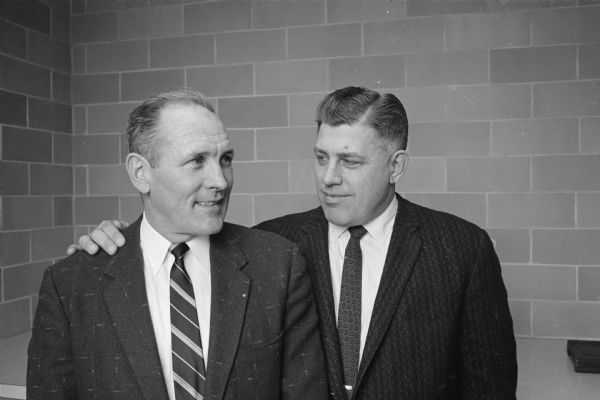 University of Wisconsin head football coach Milt Bruhn (right) welcomes new assistant coach Clark Van Galder. He was the head coach at Fresno State and had formerly coached Wisconsin high schools at South Milwaukee, Racine, and Washington Park.