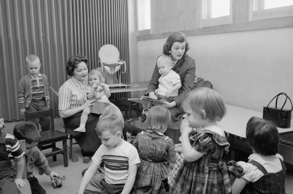When Joan Carlton of Oakpark, Illinois married Reed Forbush of Appleton, Wisconsin she was skeptical of life as a minister's wife. Now, as a series of photographs shows, she enjoys her life as the wife of the pastor of Middleton Community church. Joan in the church nursery.