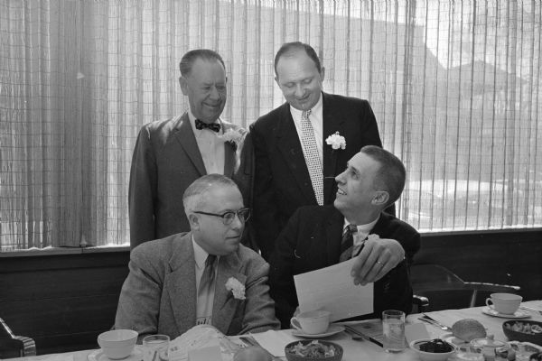 Four past presidents of the Madison Real Estate Board who were honored at the National Realtor Week luncheon. Standing are Herman Loftsgordon and Robert Keller. Seated are Willard Wagner and Phillip Stark.
