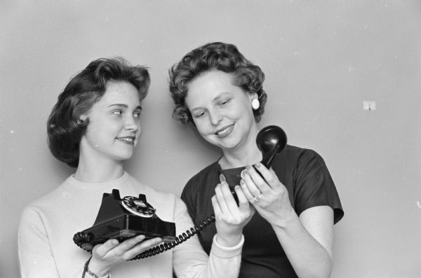 Mary Wright, left, holds the telephone for her mother Shirley, who is chair of the upcoming annual spring luncheon of the Daughters of Demeter organization.