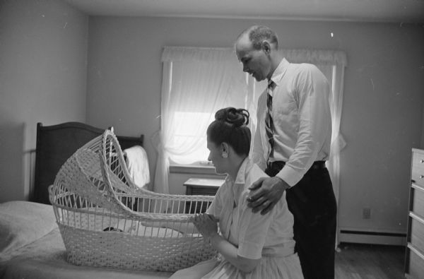 Richard and Alice Welch, 4410 Boulder Terrace, admire their new baby girl Andrea (age six days) during her first nap in her new crib at home.