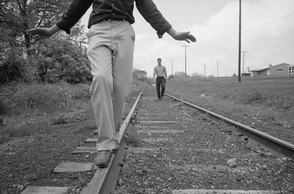 Henry Cuccia, a ninth-grader at Cherokee Heights school, demonstrates "what not to do" on the Illinois Central railroad tracks near the school as he walks down the middle of the track.