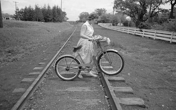 Kathy Cramer, an eighth-grader at Cherkokee Heights school demonstrates "what not to do" on the Illinois Central railroad tracks near the school by crossing with her bicycle where there is no designated crossing.