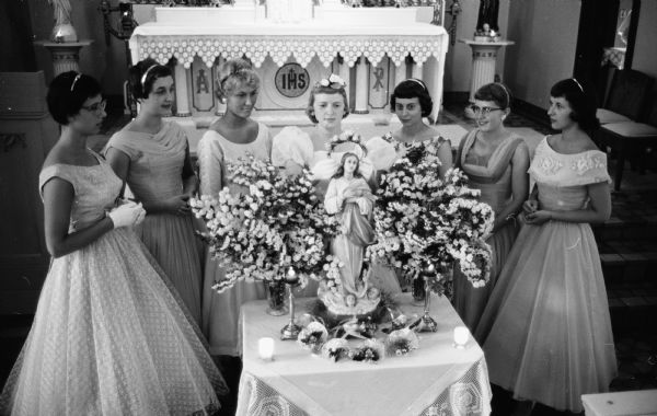 Students of St. Mary's hospital School of Nursing held their annual May crowning ceremony by crowning the statue of the Blessed Virgin with a wreath of flowers in the hospital chapel. Taking part are, (from left): Mary Jacobs, Manitowoc; Judith Klink, Elkorn; Doreen Smith, Racine; Marilyn Traut, Poynette; Kay Rauen, Burlington; Patricia McCarthy, Yuba; and Rita Rosenbaum, Fond du Lac.