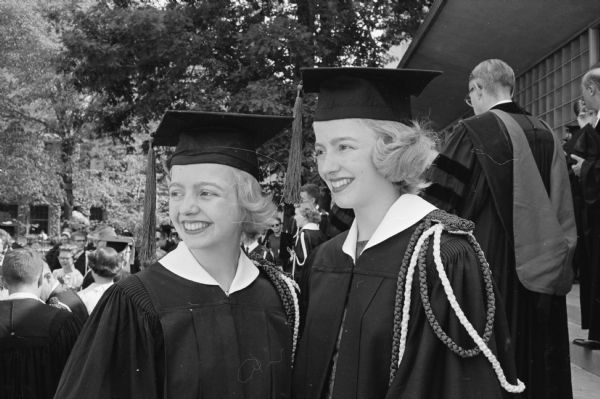 Twins Kathren (L) and Karen Olson (R), Chicago, participate in the University of Wisconsin Honor's Convocation at the UW Memorial Union theater. Both majored in Art Education and were members of Chi Omega sorority. The sisters will teach 1,300 miles apart; Kathren in Phoenix, AZ and Karen in West Allis, WI.