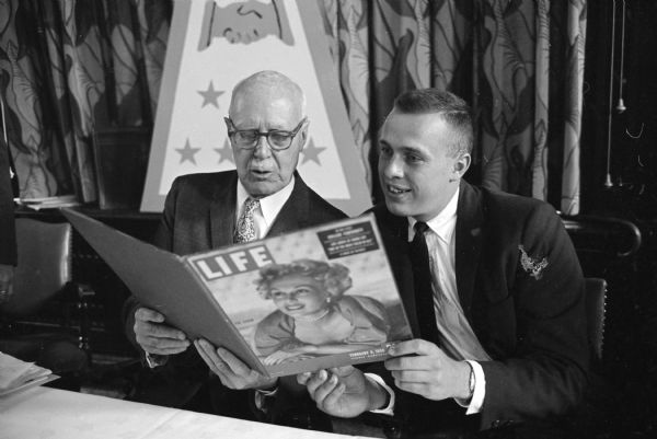 The University of Wisconsin Alpha Lambda chapter of the Sigma Chi fraternity celebrates the groups 75-year anniversary with a banquet held at the UW Memorial Union. Shown is the main speaker, Edwin B. Barlett (L), Milwaukee, UW Class of 1905, looking over a 1950 copy of <i>Life</i> Magazine which featured the Alpha Lambda chapter. James Huber (R), Madison, a current chapter member, is also looking at the magazine.
