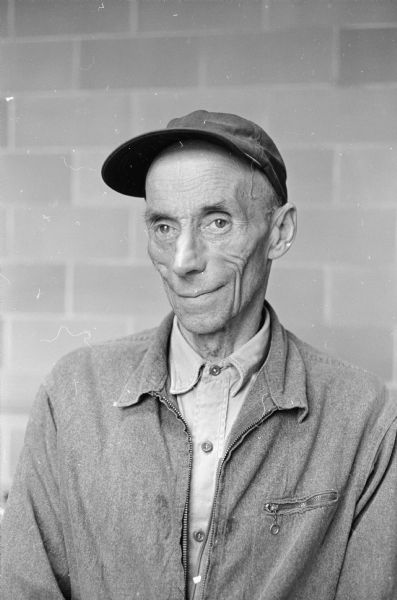 Portrait of a man wearing a cap, probably Enoch Reindahl, Stoughton. Reindahl has been photographing wild birds in the area for more than 30 years.