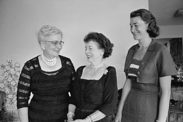 A tea is held to honor Mrs. Margery Kuehn, (shown at right) Whitefish Bay, wife of Philip Kuehn, the Republican candidate for Governor of Wisconsin. Shown at left is Mrs. Gladys Chalkley, Riverside, Calif., former dean of the Home Economics Department at Ohio State University and Montana State College. In the center is Mrs. Jane Campbell, 111 W. Wilson Street, tea hostess and sister of Mrs. Kuehn.