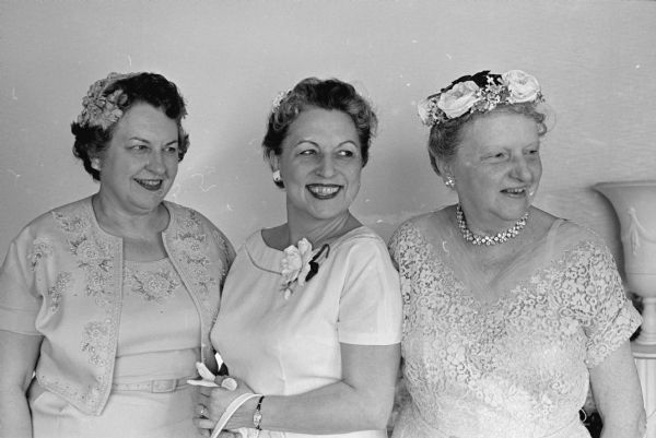 A tea is held to honor Mrs. Margery Kuehn, Whitefish Bay, wife of the Republican candidate for Governor of Wisconsin, Philip G. Keuhn. Among the women that assisted with planning and hosting the tea were, (L-R): Mrs. Constance Elvehjem, 130 N. Prospect Avenue, wife of the President of the University of Wisconsin, Conrad A. Elvehjem; Mrs. Helen Thomson, Richland Center, wife of the former Governor of Wisconsin, Vernon W. Thomson; and Mrs. Rosa Fred, 10 Babcock Drive, wife of the emeritus President of the University of Wisconsin, Edwin B. Fred.