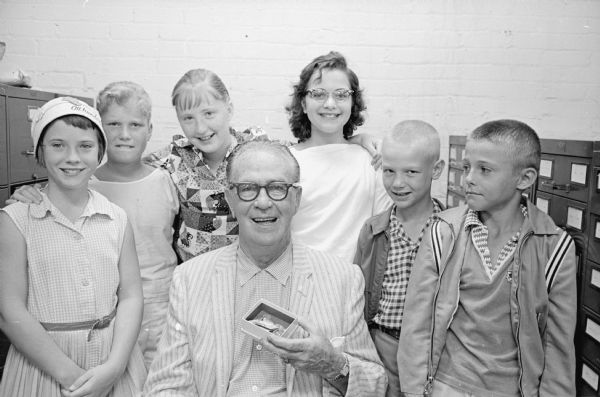 Six children who held a carnival at the residence of Mrs. Thelma Walker, at 4267 Mohawk Drive, where they raised $4.00 for the "Roundy's Fun Fund." Seated in the front row wearing a striped summer blazer is Roundy (Rodney) Caughlin. Back row, left to right: Mary Ellen Walker, Rodney Barelman, Barbara Zeier, Barbara Lynn Buckley, John Frank and David Wilkinson.