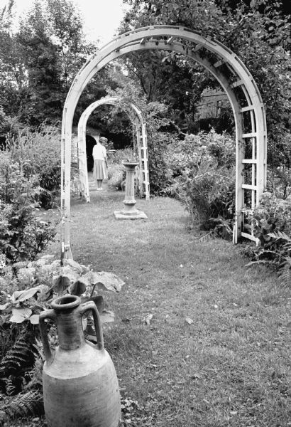 A garden path leading under two trellises in the Hanks Garden at the Lucien M. and Mary Esther "Mollie" Vilas Hanks house, 525 Wisconsin Avenue at Langdon Street. The event was the last fund raising garden walk for Attic Angels before the property was to be sold.