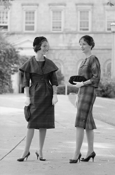 Constance and Kathleen Froker, twin graduates of Wisconsin high school in Madison and freshmen at the University of Wisconsin, model clothing that is considered appropriate for rushing sorority teas on the University of Wisconsin campus.