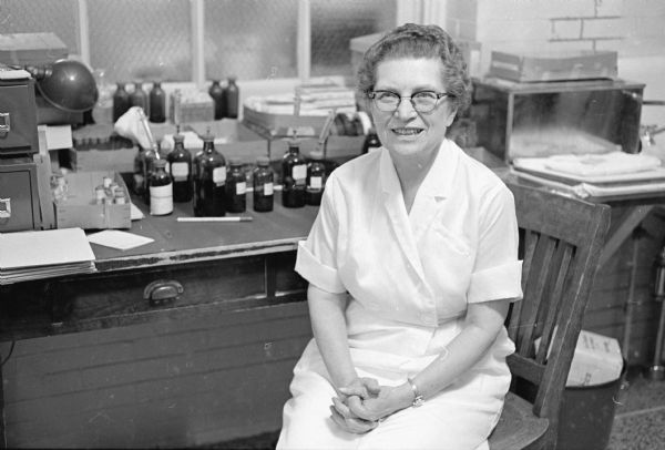 Eleanor Blankinship, age 66, is shown at her desk at the University hospital allergy clinic where she started working in 1943. She shares a house with her sister, her daughter, and two teen-aged grand-daughters. She and her daughter are both widows of doctors.