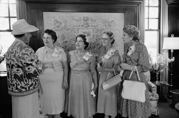 Wives of soil scientists attending a get-acquainted tea at the home of UW President & Mrs. Conrad Elvehjem. Left to right: Mrs. Hans Winterkorn, Princeton, NJ; Mrs. Constance Elvejhem; Mrs. Richard Bradfield, Ithaca, NY; Mrs. Charles F. Kellogg, Washington D.C.; Mrs. F.A. van Baren, Amsterdam, Netherlands. Their husbands are attending the 7th International Soil Science Congress on the UW campus.