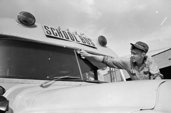 Bill Strang, Black Earth, cleans the front window of a school bus preparing for the first day of school on September 12th.