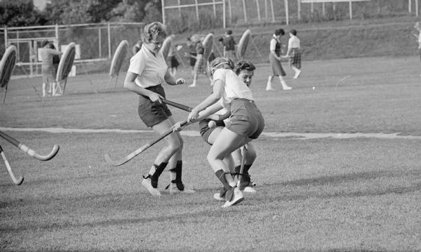 University of Wisconsin students play field hockey. "This being their first day at the game, the freshmen and sophomores were a bit clumsy."