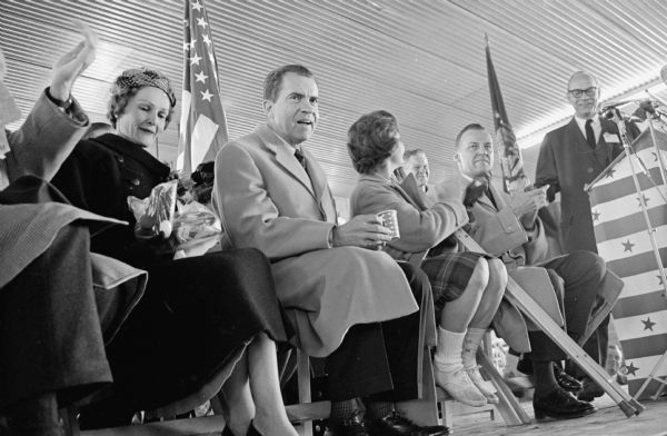 Then-Vice President Nixon on the speakers platform during a presidential campaign stop at the Madison Municipal airport. With him are his wife, Pat; injured young Republican volunteer Lynn Cooperman from Chicago; and Phillip Kuehn, Republican candidate for governor.