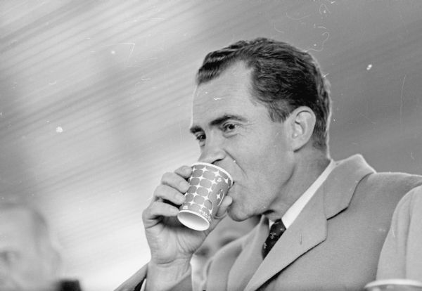 Then-Vice President Nixon enjoys a cup of coffee during a presidential campaign stop at the Madison Municipal airport.