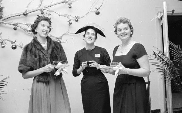 Three committee chairmen of the Truax Field Officers' Wives club during a tea for wives of a number of prominent Madison residents. They are, left to right, Patricia Harris, Margaret Hoffman, and Mrs. James Ridgell.