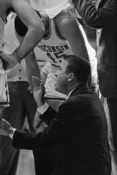 Wisconsin basketball coach John Erickson explains a strategy during a timeout of the Wisconsin vs Air Force Academy basketball game in the University of Wisconsin Field House.