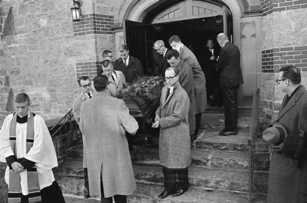 Members of the <i>Wisconsin State Journal</i> staff carry the coffin bearing the body of editor Roy L. Matson from St. Andrews Episcopal Church. Rector Robert C. Shaw at left.