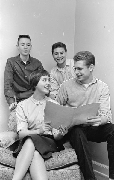 Four youth planning the Nakoma young people's party to be held at the Nakoma school posing sitting together. In back are David Knope and Jim Martin. Seated in front are Phoebe Chidester and Ron De Golier.