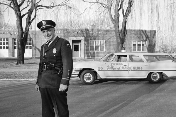 A.J. Taff, Maple Bluff police marshal, 6 Fuller Drive, conducts a one-man census of the village for the annual village directory. Taff has conducted the census for 35 years since 1925. The village was incorporated in 1930. Taff is shown standing in front of the Maple Bluff village hall.