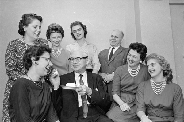 Superior Judge Roy H. Proctor celebrates his birthday with his staff at a luncheon at the Hotel Loraine. Proctor turns 69 on December 18, 1960. He has been on the bench for 28 years. Proctor is shown giving the first piece of his birthday cake to his secretary, Jackie Ripp. Shown in the background (L-R) are Julia Kuepper, Deputy Clerk; Katherine Ramberg; Betty Kissow; Melvin Bailey, bailiff; Virginia McRedmond, clerk; and Greta Basso.