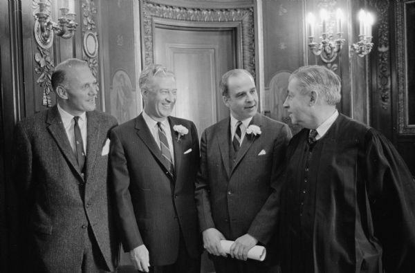 A pre-inauguration conversation in the governor's office. Left to right are: Secretary of State Robert C. Zimmerman, Lieutenant Governor Warren P. Knowles, Governor Gaylord Nelson, and Chief Justice John D. Martin.