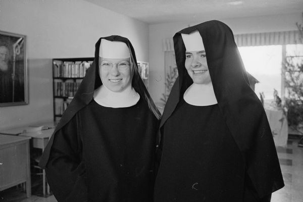 Posing for a photograph following a High Mass in the chapel of the Academy of St. Benedict during which they professed their temporary vows in the order of St. Benedict are Novice Sisters Mary Christine, left, and Mary David.